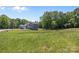Backyard view of house showing large grassy lawn and treeline at 106 Desert Sky Ct, Statesville, NC 28625