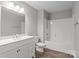 Bright bathroom featuring a white vanity with drawers, large mirror, toilet, and a shower-tub combo at 106 Desert Sky Ct, Statesville, NC 28625