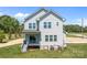 New two-story home with gray siding, multiple windows, covered porch, and a partially-cleared lot at 106 Desert Sky Ct, Statesville, NC 28625