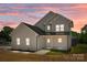 Stunning two-story home with a beautifully illuminated exterior at dusk at 106 Desert Sky Ct, Statesville, NC 28625