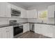 Beautiful kitchen with white cabinetry, a subway tile backsplash, and stainless steel appliances at 106 Desert Sky Ct, Statesville, NC 28625