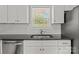 A well-lit kitchen with white cabinets, dark countertops, and stainless steel appliances at 106 Desert Sky Ct, Statesville, NC 28625
