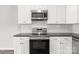 Kitchen featuring stainless steel appliances, white cabinets, and a subway tile backsplash at 106 Desert Sky Ct, Statesville, NC 28625