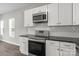 Updated kitchen with white cabinets, stainless steel appliances, and great natural light at 106 Desert Sky Ct, Statesville, NC 28625