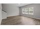 Spacious living room with lots of natural light and wood-look flooring at 106 Desert Sky Ct, Statesville, NC 28625