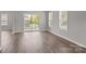 Bright living room featuring wood-look floors, a sliding glass door, and ample natural light from large windows at 106 Desert Sky Ct, Statesville, NC 28625