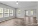 Bright and airy living room featuring wood-look floors and multiple windows offering abundant natural light at 106 Desert Sky Ct, Statesville, NC 28625