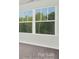 Bright bedroom window overlooking lush trees, creating a nature-filled oasis at 11135 Cardinal Creek Ave, Charlotte, NC 28215