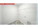 The laundry room contains shelving for storage above the washer/dryer hookups at 11135 Cardinal Creek Ave, Charlotte, NC 28215