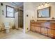 Bright bathroom features a tiled shower, window, vanity and neutral color palette at 1119 Palmyra Dr, Tega Cay, SC 29708