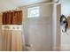 Bathroom with a shower featuring a curtain and a decorative window at 1119 Palmyra Dr, Tega Cay, SC 29708