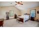 Bedroom featuring a bed, bench, two windows, ceiling fan and warm, neutral color palette at 1119 Palmyra Dr, Tega Cay, SC 29708