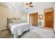 Bright bedroom featuring a comfortable bed, ceiling fan, closet, and natural light from the window at 1119 Palmyra Dr, Tega Cay, SC 29708