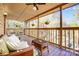 Relax on the covered deck with comfortable seating and scenic views at 1119 Palmyra Dr, Tega Cay, SC 29708