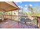 Enjoy outdoor dining on the covered deck overlooking the trees and neighborhood at 1119 Palmyra Dr, Tega Cay, SC 29708