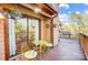 Relax on the deck with charming yellow chairs and mature landscaping at 1119 Palmyra Dr, Tega Cay, SC 29708