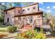 Charming two-story home with a wooden deck and colorful flower garden in the front yard at 1119 Palmyra Dr, Tega Cay, SC 29708