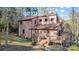 Two-story home with a sloped roof and wooden deck in a wooded setting at 1119 Palmyra Dr, Tega Cay, SC 29708