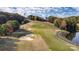 Enjoy this aerial view of the manicured golf course offering lush greens, sand traps, and serene pond at 1119 Palmyra Dr, Tega Cay, SC 29708