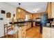 Kitchen featuring custom wood cabinets, black countertops, and modern appliances at 1119 Palmyra Dr, Tega Cay, SC 29708