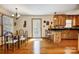 Charming kitchen with wooden cabinets, granite countertops, and an open dining space at 1119 Palmyra Dr, Tega Cay, SC 29708