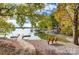 This beautiful waterfront view offers a dock, bench, and peaceful lake, inviting relaxation by the water at 1119 Palmyra Dr, Tega Cay, SC 29708