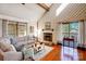 Cozy living room with a stone fireplace, vaulted ceiling, and natural light at 1119 Palmyra Dr, Tega Cay, SC 29708