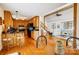 Open floor plan showcasing kitchen, dining area, and living room with hardwood floors and natural light at 1119 Palmyra Dr, Tega Cay, SC 29708