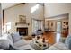 Open living room with hardwood floors and a fireplace that connects to the dining area at 1119 Palmyra Dr, Tega Cay, SC 29708