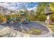 Community playground with slides and mature trees in the background at 1119 Palmyra Dr, Tega Cay, SC 29708