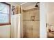 The shower features tile walls, a shower curtain, a window, and neutral color palette at 1119 Palmyra Dr, Tega Cay, SC 29708