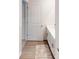 Bright bathroom with a light wood floor, a long vanity, and a doorway looking into a bedroom at 11216 Cardinal Creek Ave, Charlotte, NC 28215
