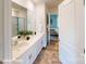 Modern bathroom with dual sinks, quartz countertops, and a glass-enclosed shower at 11216 Cardinal Creek Ave, Charlotte, NC 28215