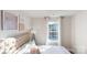 Cozy bedroom with a comfortable bed, large window, and decorative wall art at 11216 Cardinal Creek Ave, Charlotte, NC 28215