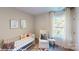 Bright Bedroom featuring a crib, chair, and large window offering plenty of natural light at 11216 Cardinal Creek Ave, Charlotte, NC 28215