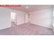 Carpeted bedroom with an open doorway into the en-suite bathroom at 11216 Cardinal Creek Ave, Charlotte, NC 28215