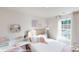Comfortable bedroom featuring a bed, desk, and large window with natural light at 11216 Cardinal Creek Ave, Charlotte, NC 28215