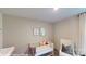 Bright Bedroom with stylish decor, white crib, and a comfortable chair near the window at 11216 Cardinal Creek Ave, Charlotte, NC 28215