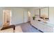 Relaxing bedroom with a decorative cabinet, soft carpet, and artwork, creating a serene and stylish space at 11216 Cardinal Creek Ave, Charlotte, NC 28215