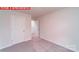 A bedroom featuring neutral walls, carpet flooring, and white doors leading to other rooms in the house at 11216 Cardinal Creek Ave, Charlotte, NC 28215