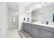 Modern bathroom with double vanity, granite countertops, gray cabinets, and marble floors at 120 Keats Aly, Cramerton, NC 28032