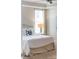 Bright bedroom with a white bed, side table with lamp, and large window with curtains at 120 Keats Aly, Cramerton, NC 28032