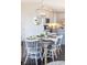 Dining room with table and chairs, decorated place settings, pendant light, and view into the kitchen at 120 Keats Aly, Cramerton, NC 28032