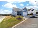 View of the blue home with an attached garage and newly installed driveway at 120 Keats Aly, Cramerton, NC 28032