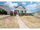 Attractive blue two-story house featuring a covered front porch and well-maintained lawn at 120 Keats Aly, Cramerton, NC 28032