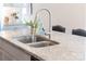 Kitchen island with a stainless steel sink, faucet, and light colored countertops at 120 Keats Aly, Cramerton, NC 28032