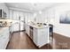 Bright, modern kitchen with white cabinets, stainless steel appliances, and a large granite island at 120 Keats Aly, Cramerton, NC 28032