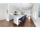 Spacious kitchen island with gray cabinets, granite countertops, stainless appliances and seating for four at 120 Keats Aly, Cramerton, NC 28032
