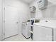 Bright laundry room with white washer and dryer and shelving for organized storage at 120 Keats Aly, Cramerton, NC 28032