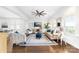 Bright living room with hardwood floors, large windows, and a large ceiling fan at 120 Keats Aly, Cramerton, NC 28032